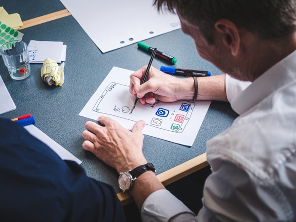 man making a paper prototype